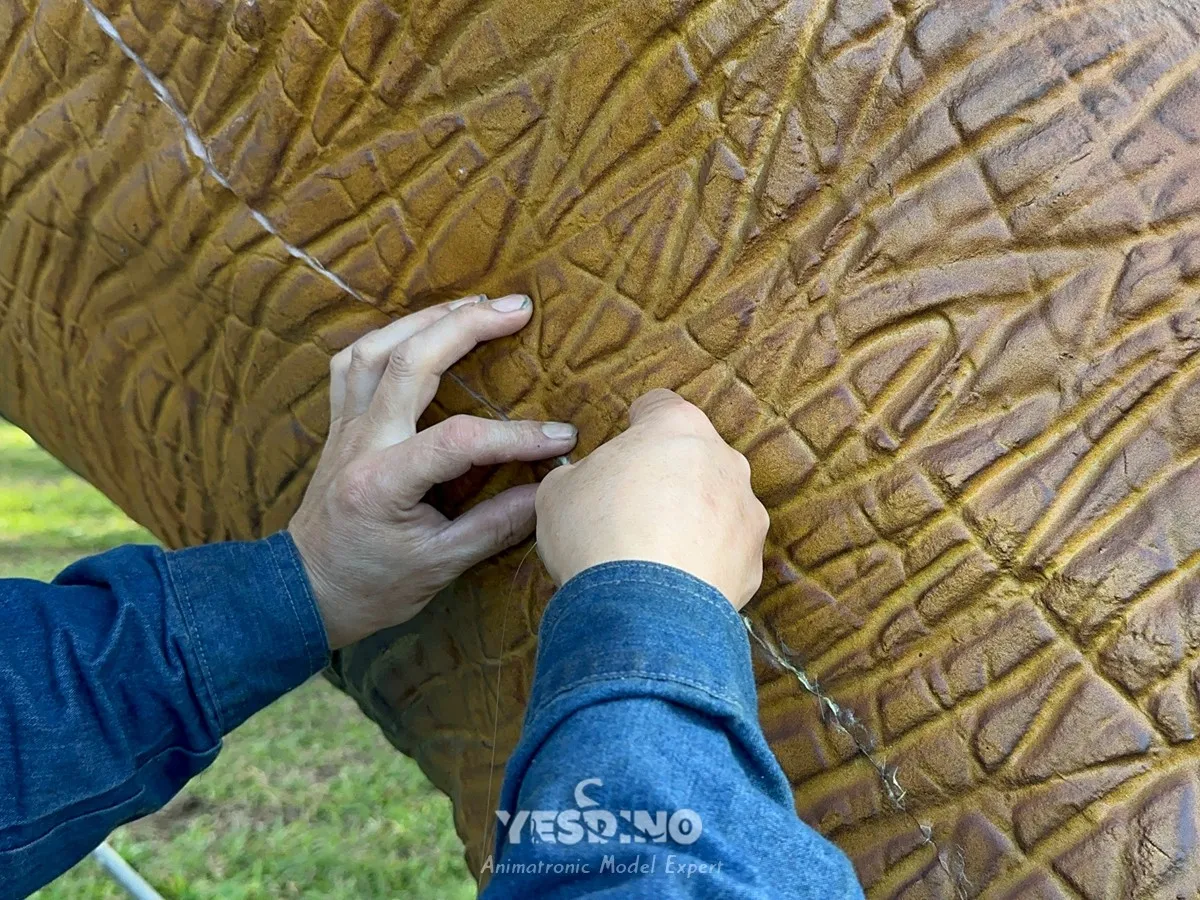 Workers stitching cuts on silicone skin