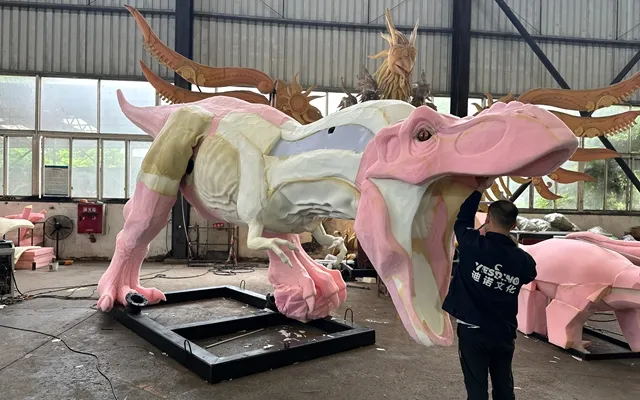 Step 4: hand-sculpting the high-density foam body of a dinosaur model